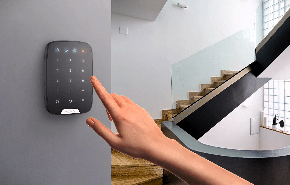 hand using black wall keypad