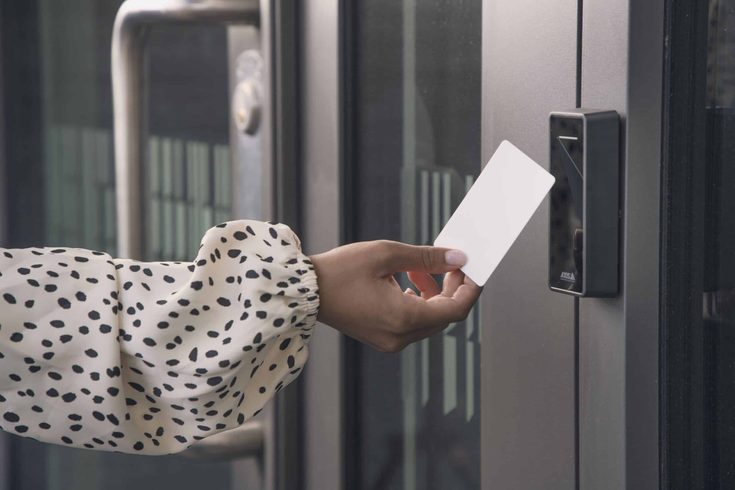 person uses card to access condo door