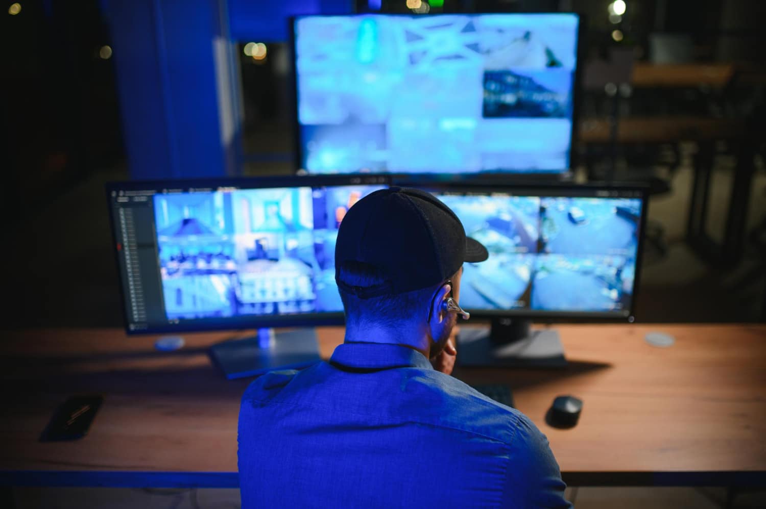security official monitoring cctv screens