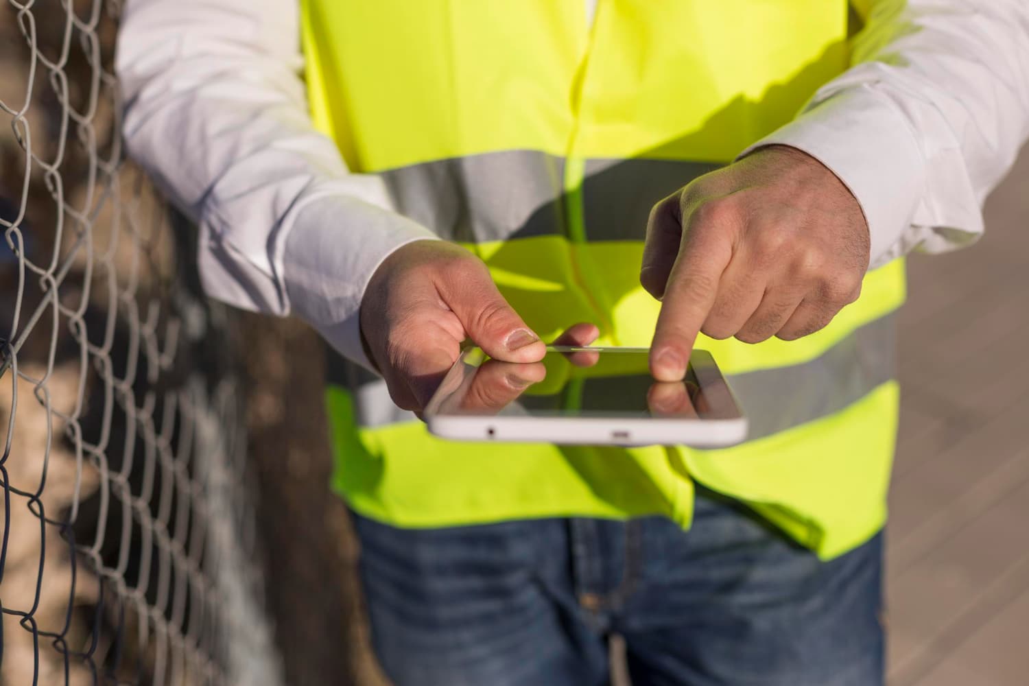 person using tablet on construction site