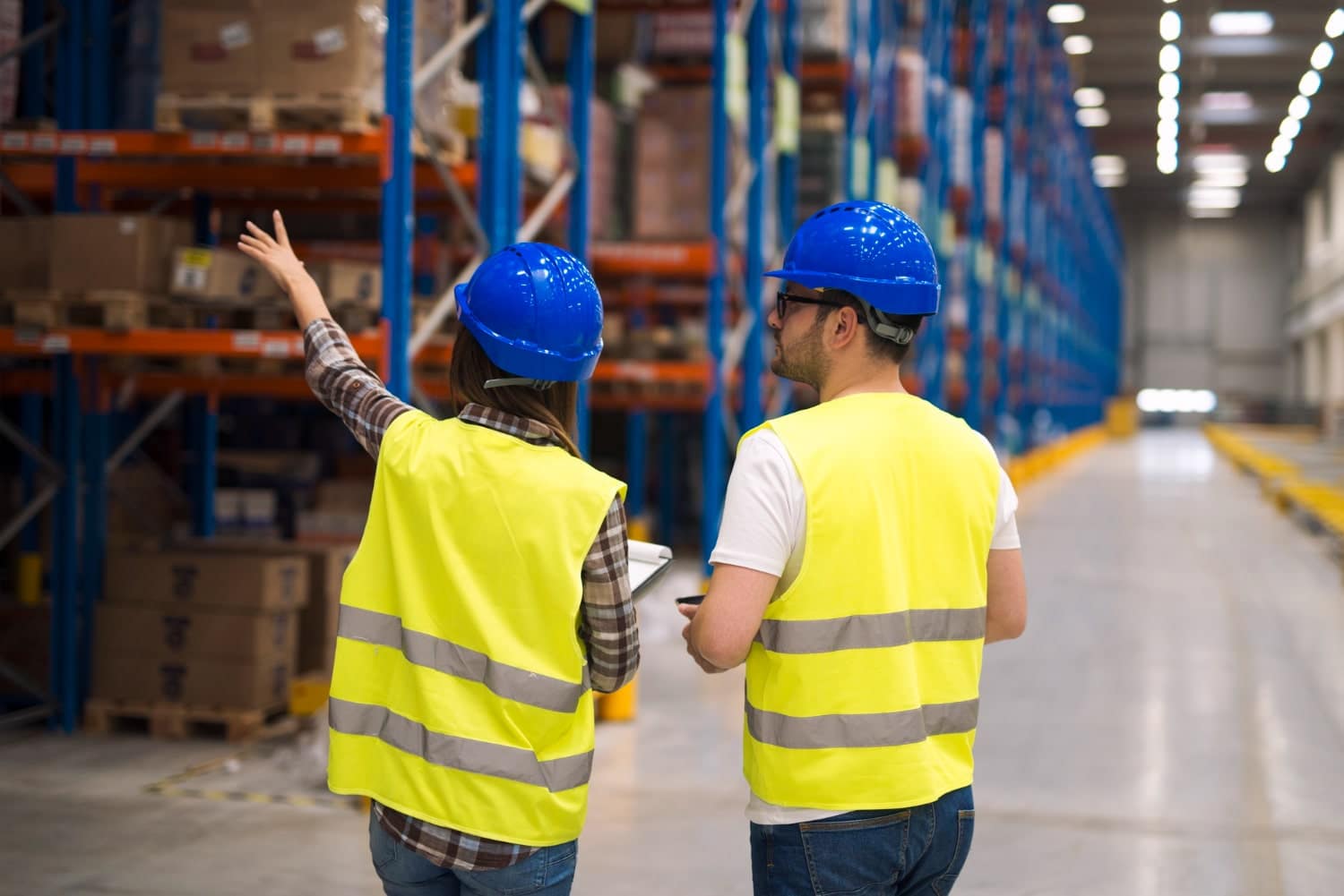 workers in a warehouse with helmets